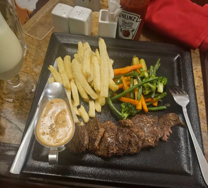 Steak plate with fries, vegetables, and sauce at Lilian Tower Cafe